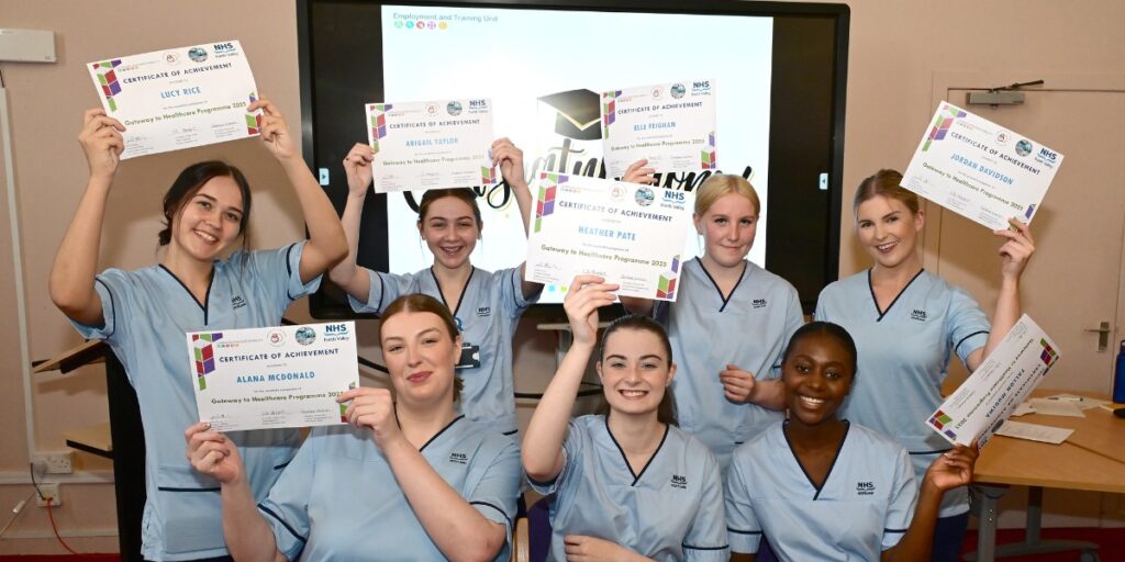 Healthcare Academy graduates celebrate with their certificates at Grangemouth Municipal Chambers.
